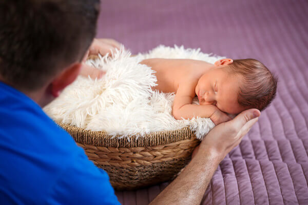 Photographer at work with newborn baby boy
